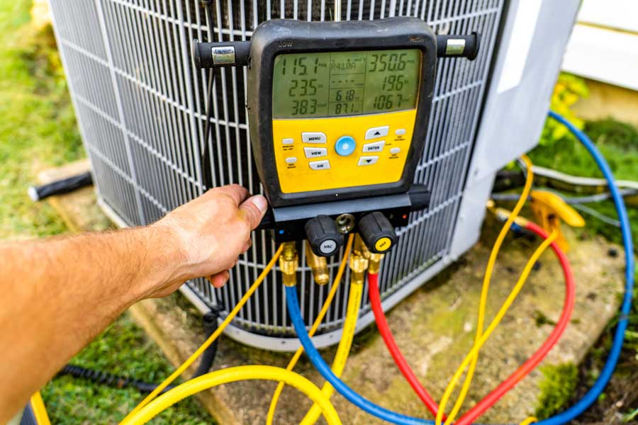 Technician repairing AC condenser unit
